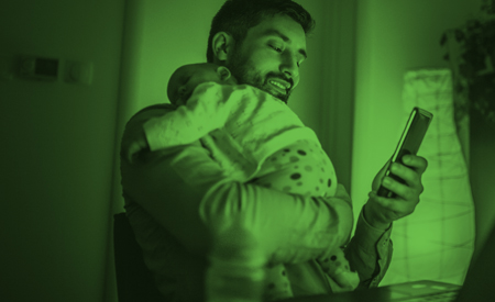Man Holding Child Searching for Installment Loans Online - Check `n Go