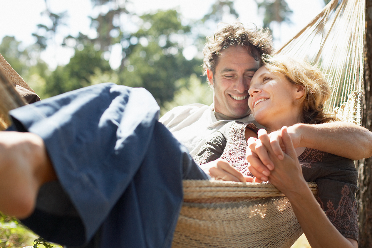 Couple Happy About Installment Loan Sitting in Hammock - Check 'n Go