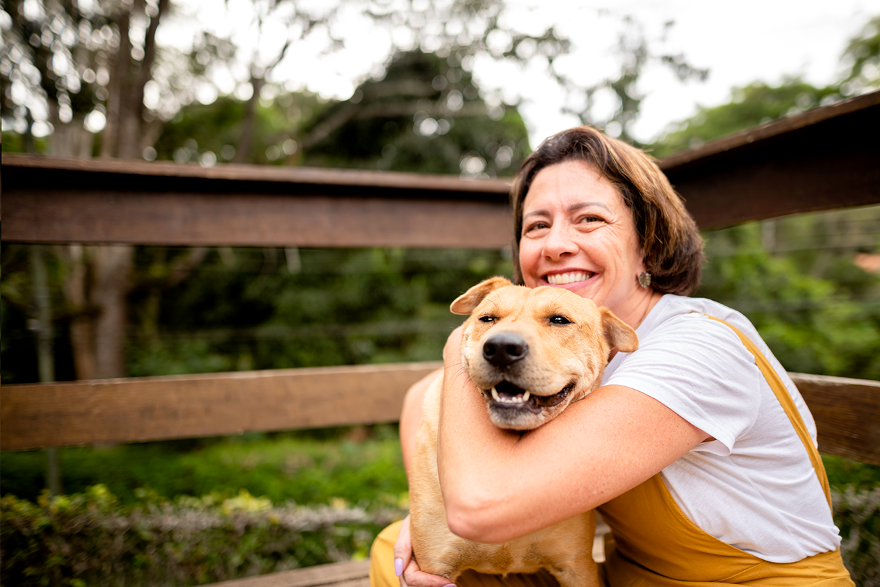 Woman Hugging Her Dog Outside - Check 'n Go