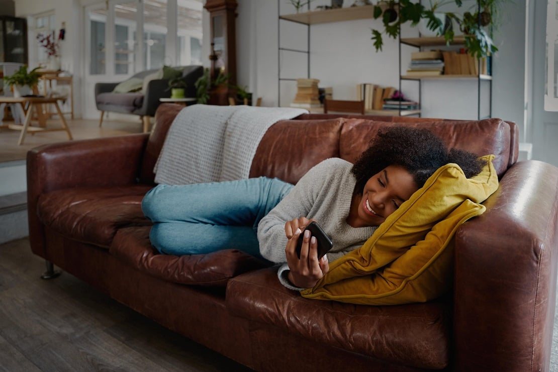person on couch using phone