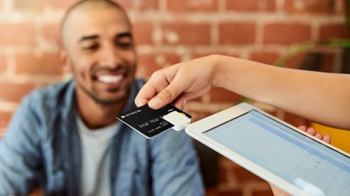 Man Paying Bill with Credit Card - Check `n Go