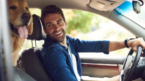 Smiling Man Driving with Dog - Check `n Go