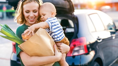 Woman Carrying Groceries & Baby - Check `n Go