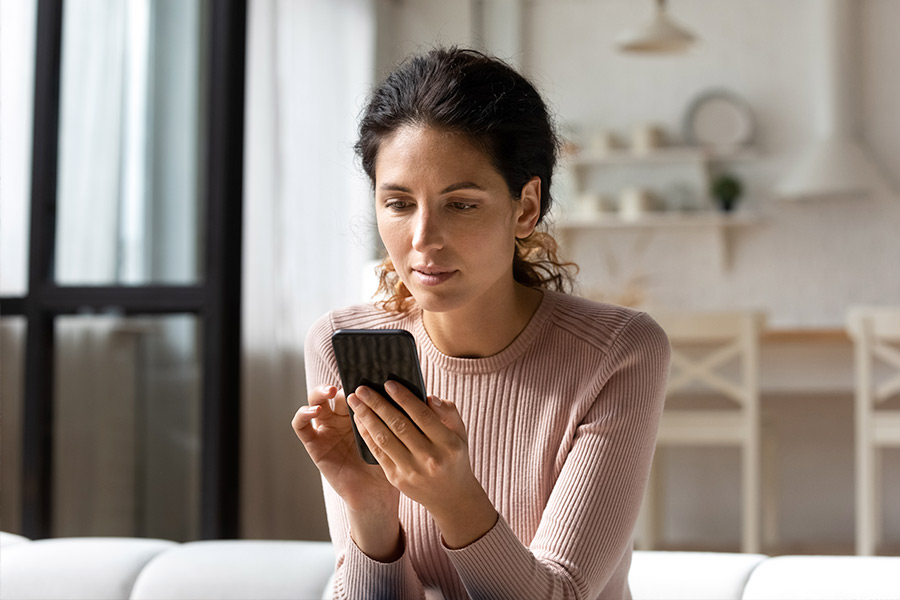 Woman Comparing Loans on Mobile - Check `n Go