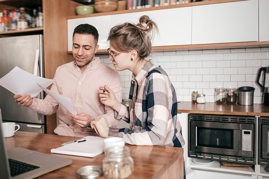Couple Reviewing Tax Help Documents in the Kitchen