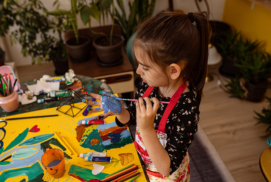 Little Girl Painting and Working on Arts and Crafts