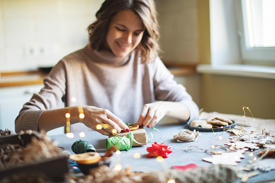 Woman wrapping a Christmas gift.