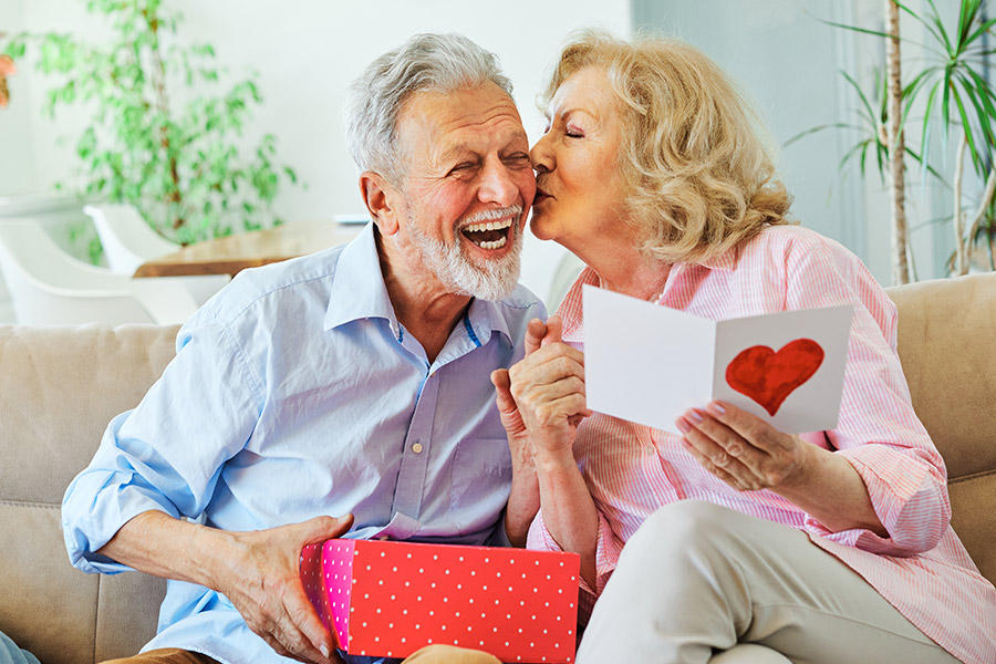 Happy Elderly Couple With Valentine's Day Gifts