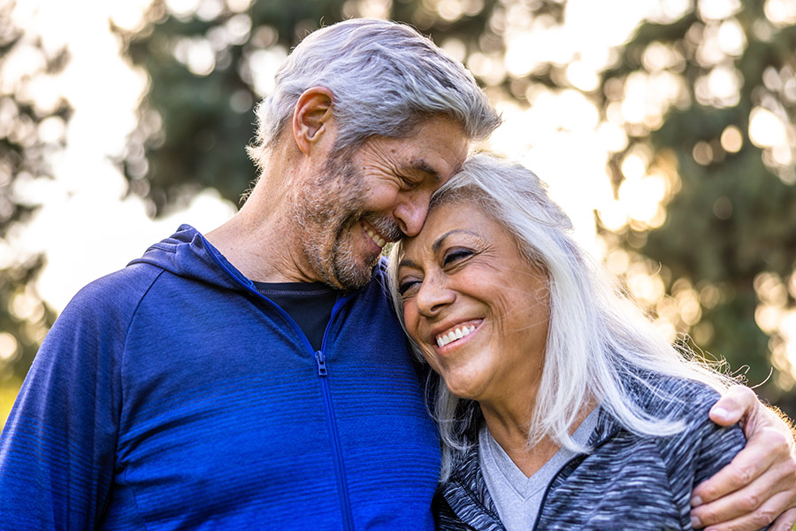 Happy Senior Couple Embracing Outdoors