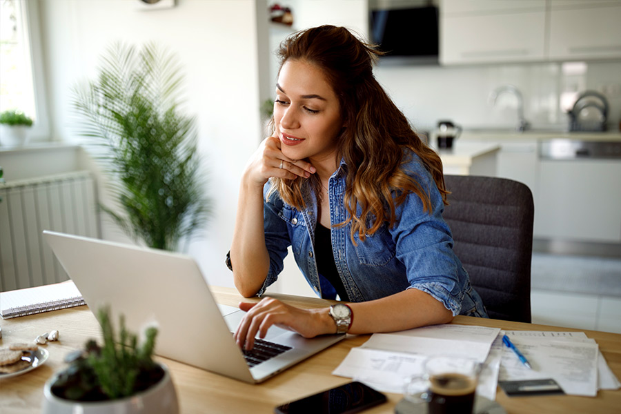 Woman Researching Installment Loans on Laptop - Check `n Go