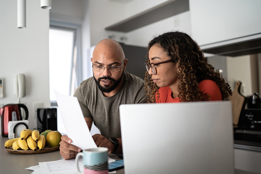 Man and Woman Reviewing Installment Loan Documents