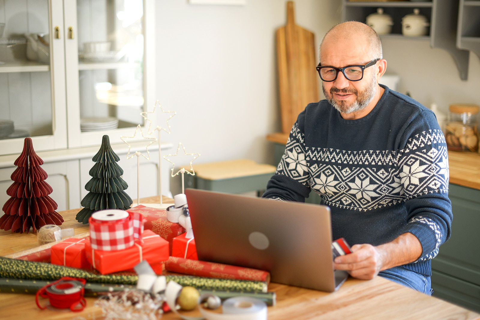 Man Creating Holiday Gifts Budget on Laptop - Check `n Go