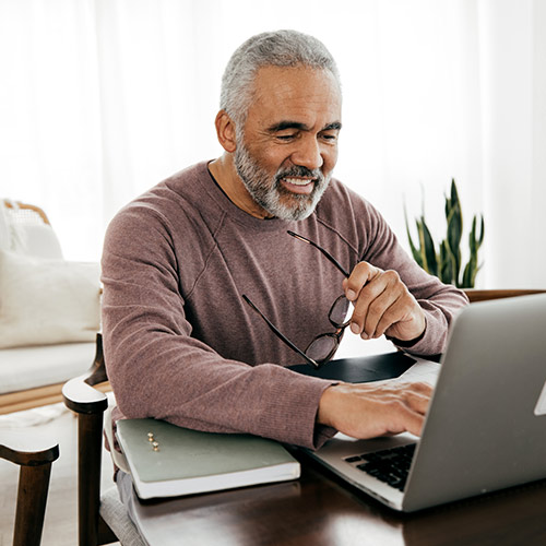 Man Viewing Tax Refund on Laptop
