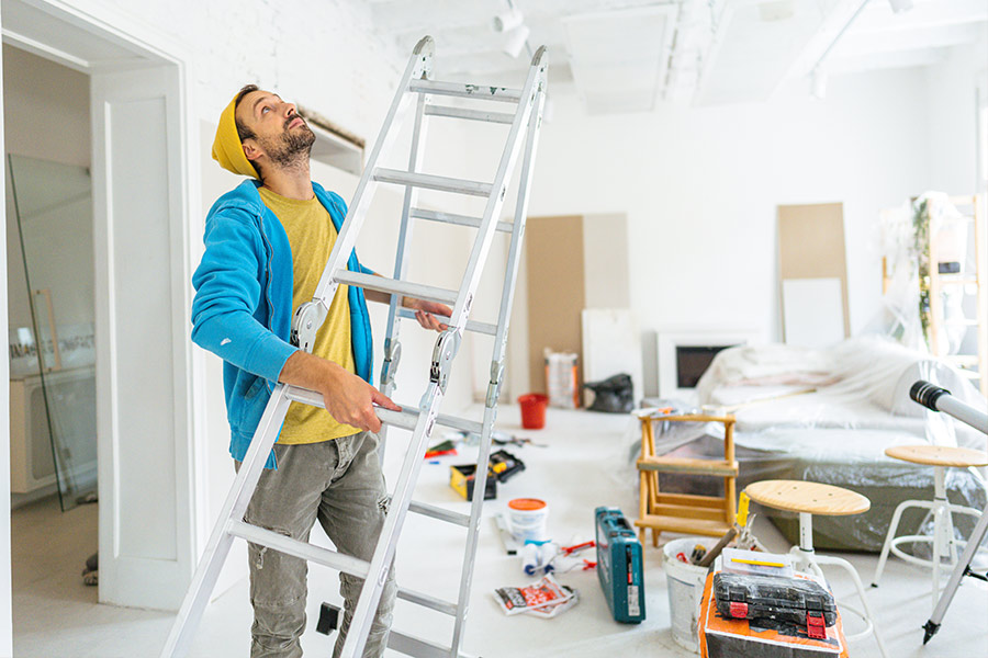 Man with Ladder Working on Home Renovations