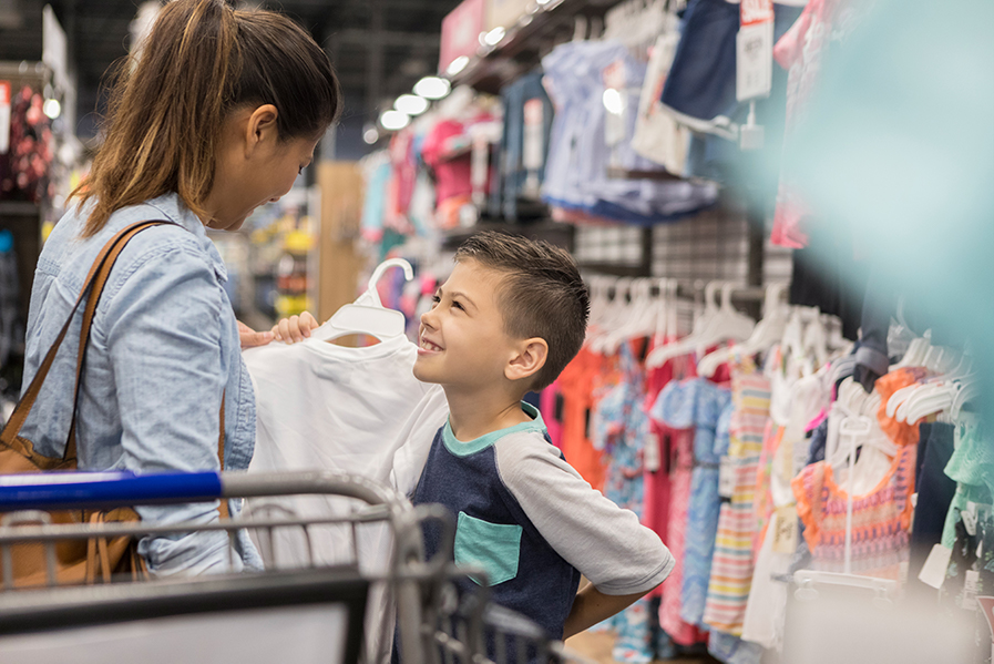 Mom and young son clothing shopping.