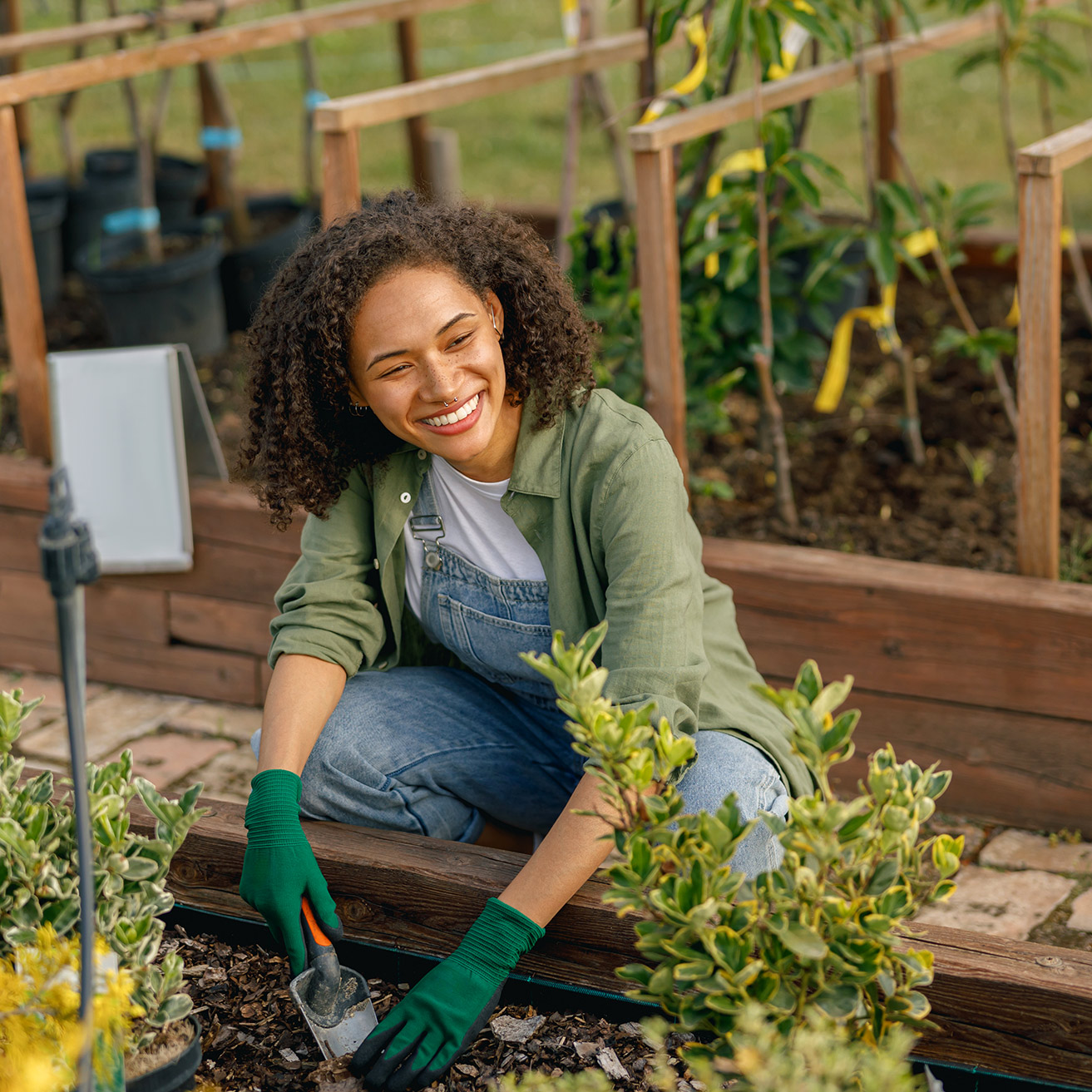 Smiling Young Woman Gardening