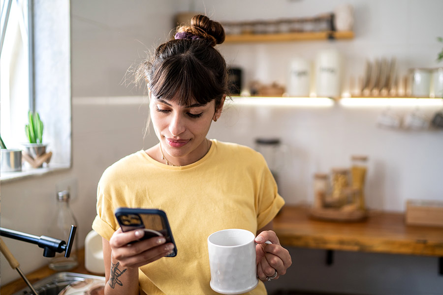 Woman Applying for Online Loan on Phone - Check `n Go