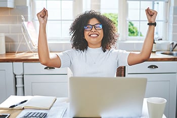 Woman Celebrating Being Approved for an Installment Loan - Check `n Go