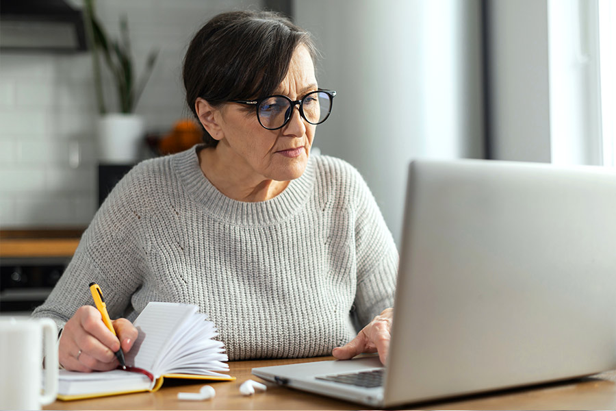 Woman Reviewing her Bills - Check `n Go