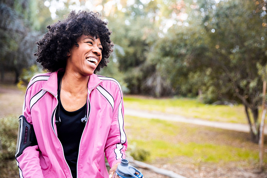 Woman Smiling While Taking a Walk Outside