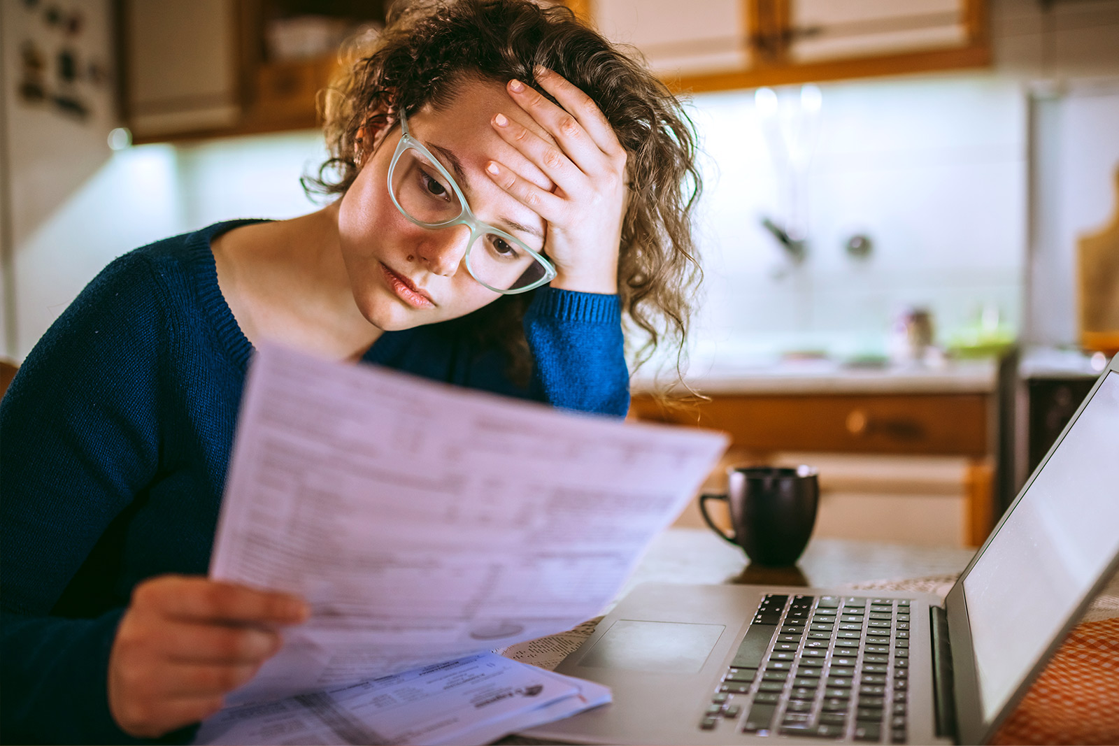 Woman Worriedly Reviewing Documents - Check `n Go