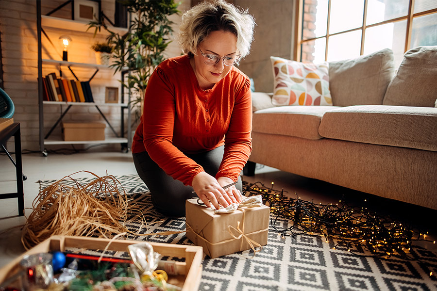 Woman Wrapping Gifts at Home