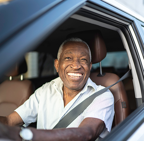 Happy Smiling Man Driving a Car