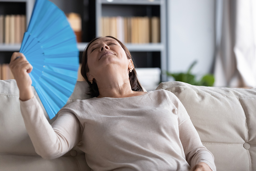 Woman using a handheld fan