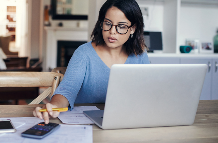 Woman Reviewing Her Credit Card Debt on Laptop