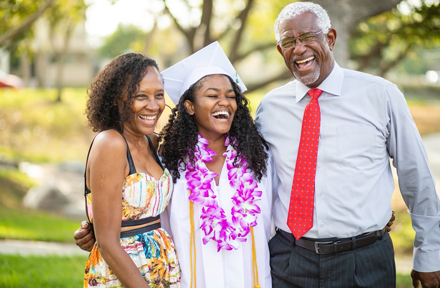 Mom and dad with their daughter on graduation day