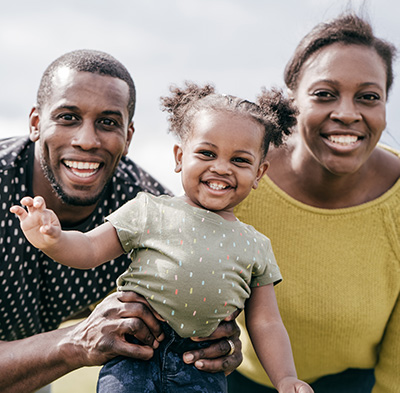 Smiling Young Couple with Happy Baby Girl