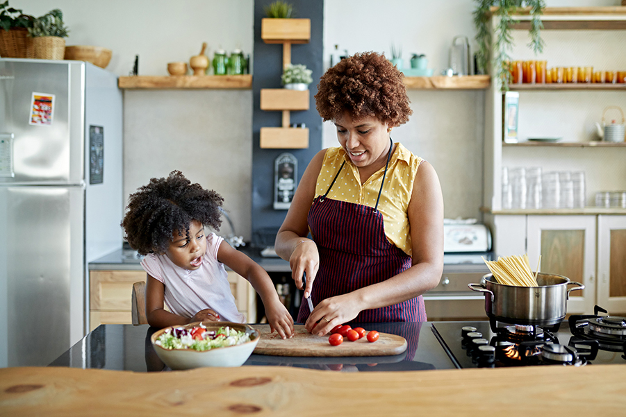 Mom and Young Daughter Cooking at Home